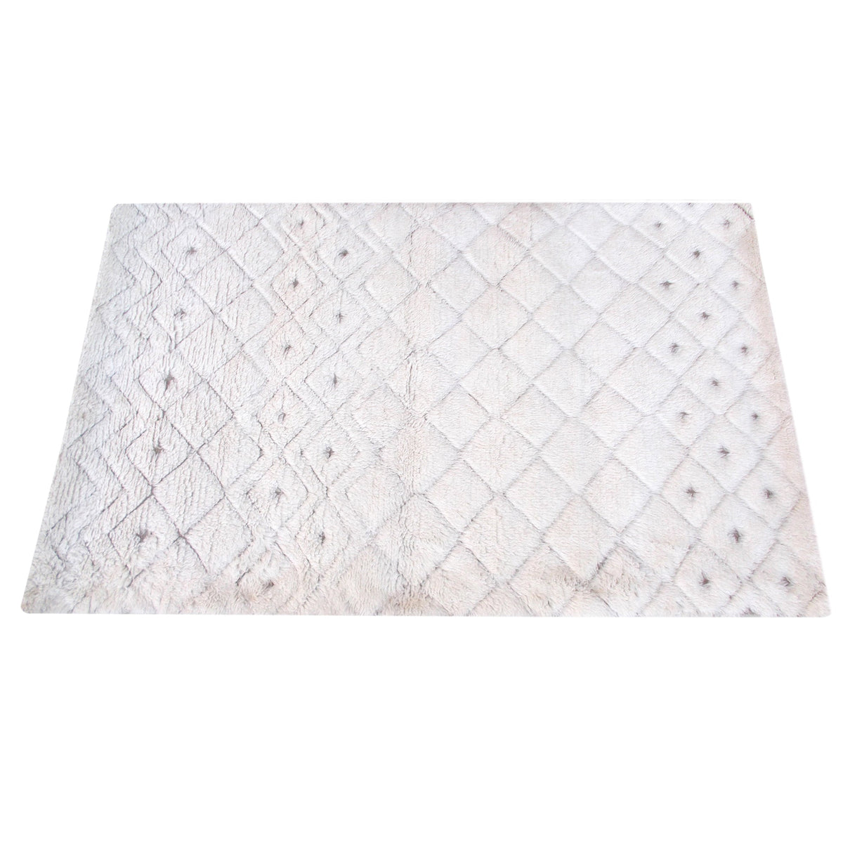 Til handwoven New Zealand wool flatweave rug with an ivory diamond lattice and dots, in a living room