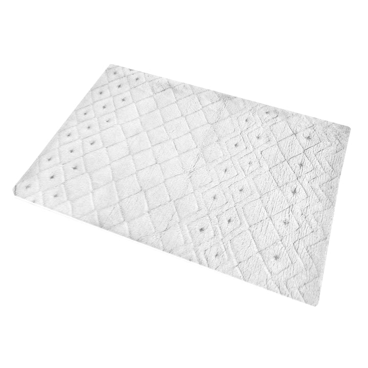 Til handwoven New Zealand wool flatweave rug with an ivory diamond lattice and dots, in a living room