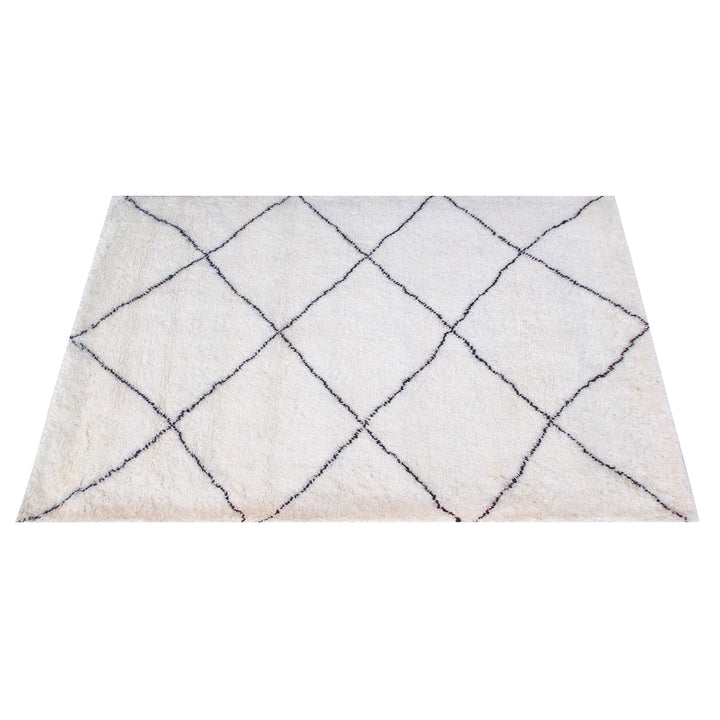 Snowfield handwoven wool rug with fine charcoal diamond lattice on ivory, in a study