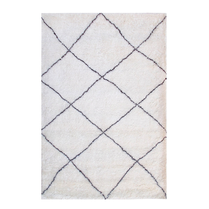 Snowfield handwoven wool rug with fine charcoal diamond lattice on ivory, in a study