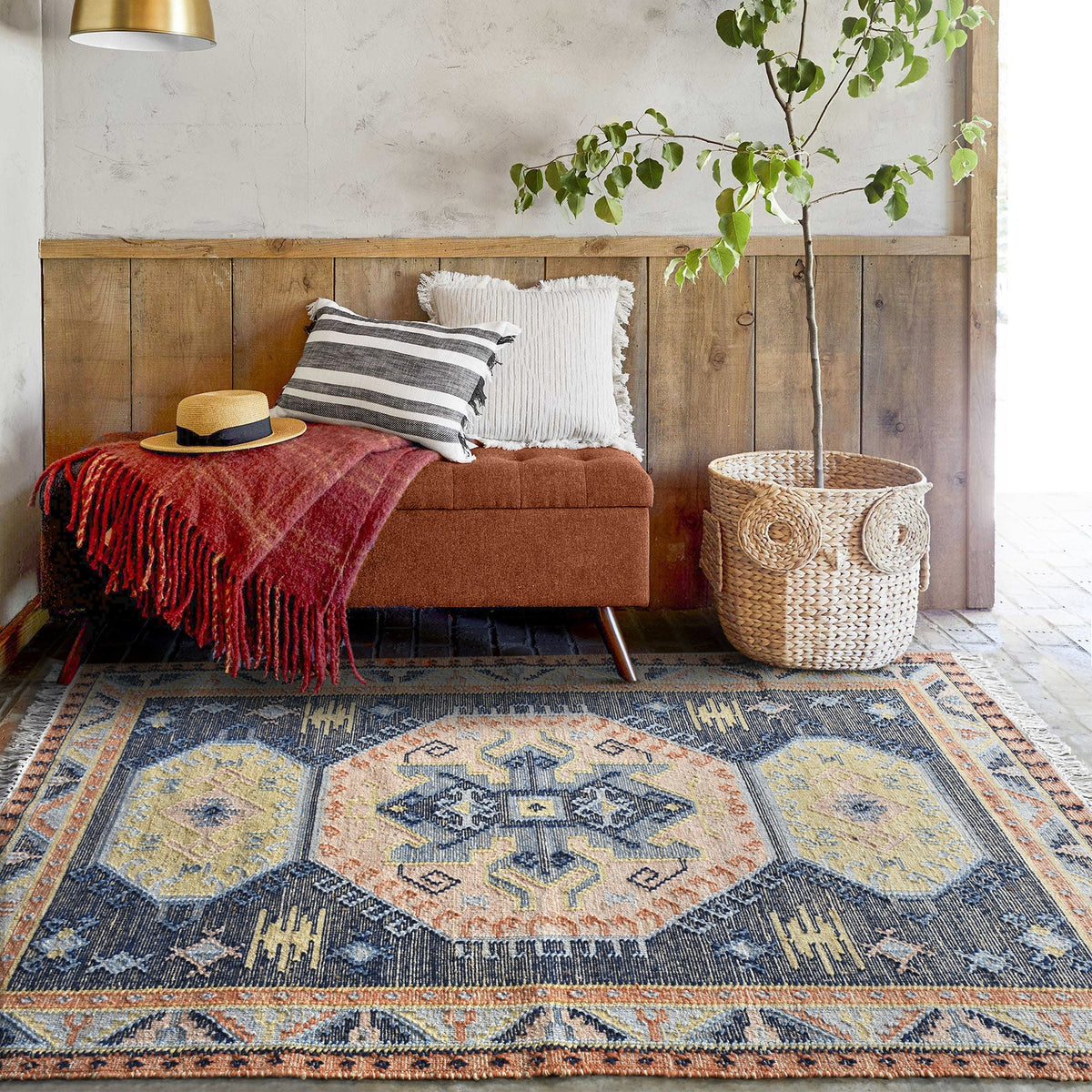 Harbour flatweave navy wool and hemp kilim rug with gold and rust medallions, in an entryway