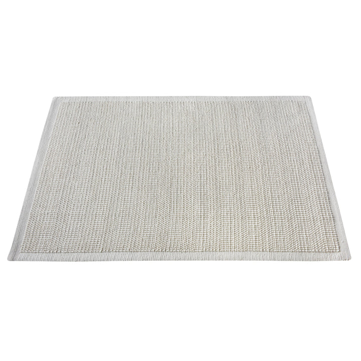 Basket handwoven cream wool rug with basketweave texture and tonal border, in a bedroom