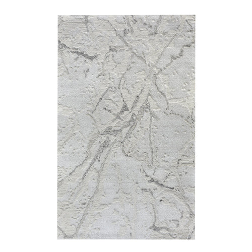 Daali handwoven wool and viscose rug with grey carved branch lines on ivory, in a bedroom
