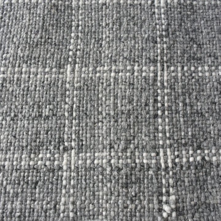 Pavilion handwoven slate grey and ivory recycled PET rug with a window-pane check, on a patio