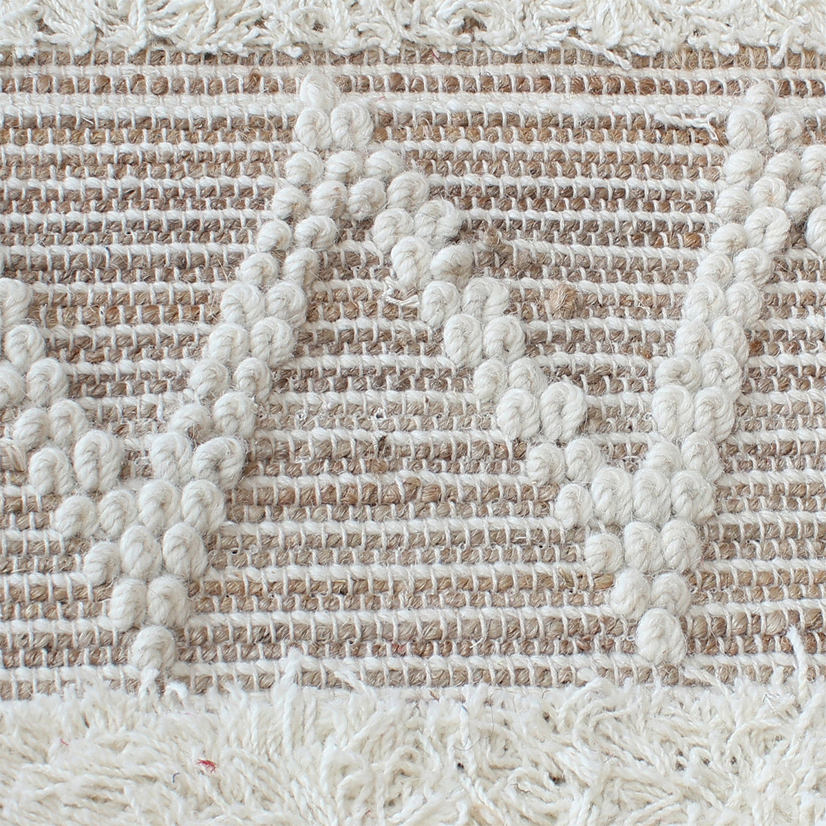 Barley handwoven hemp and wool rug with raised ivory diamonds on cream, in a living room