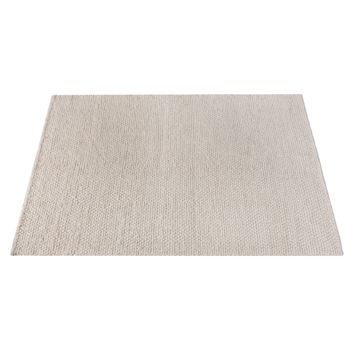 Bunai handwoven wool rug with a chunky looped bouclé surface in oatmeal, in a living room