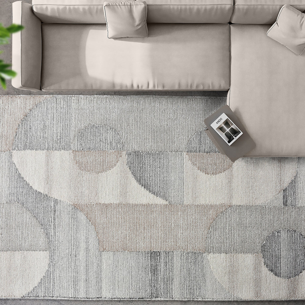 Ghera handwoven pale grey wool rug with overlapping cream circles, in a living room