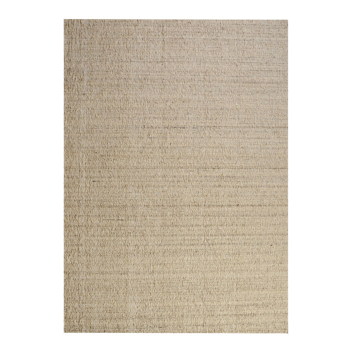 Saada handwoven flat wool rug in solid stone beige with charcoal, in a living room
