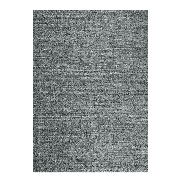 Saada handwoven flat wool rug in solid stone beige with charcoal, in a living room