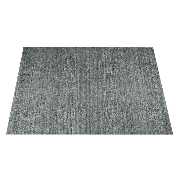 Saada handwoven flat wool rug in solid stone beige with charcoal, in a living room