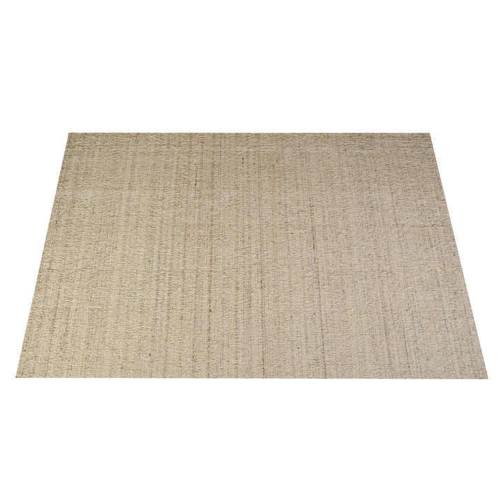 Saada handwoven flat wool rug in solid stone beige with charcoal, in a living room