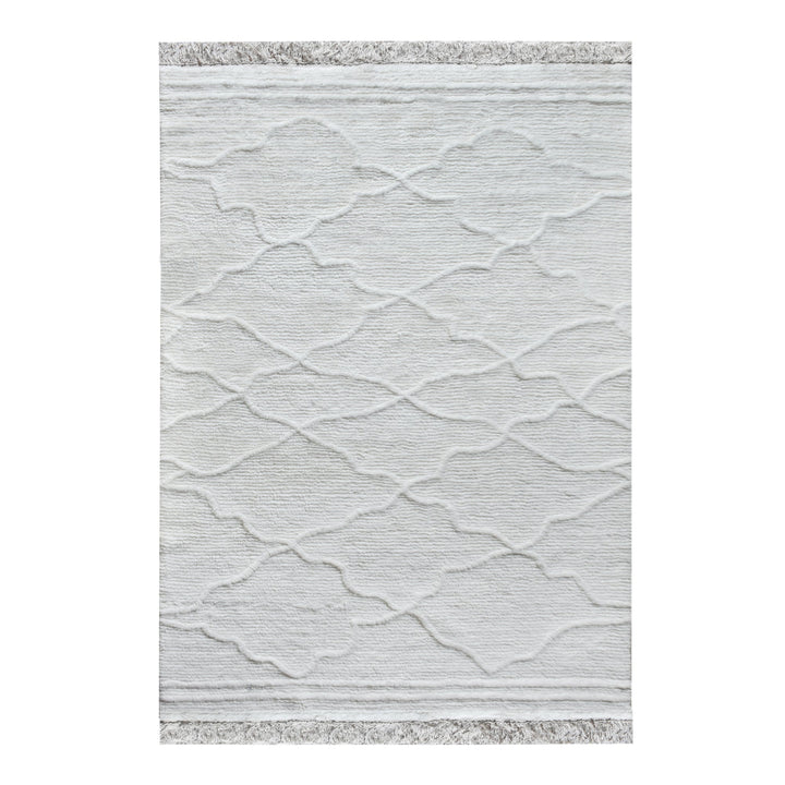 Kangan tufted wool rug with a tonal carved Moroccan lattice in bone ivory, in a bedroom