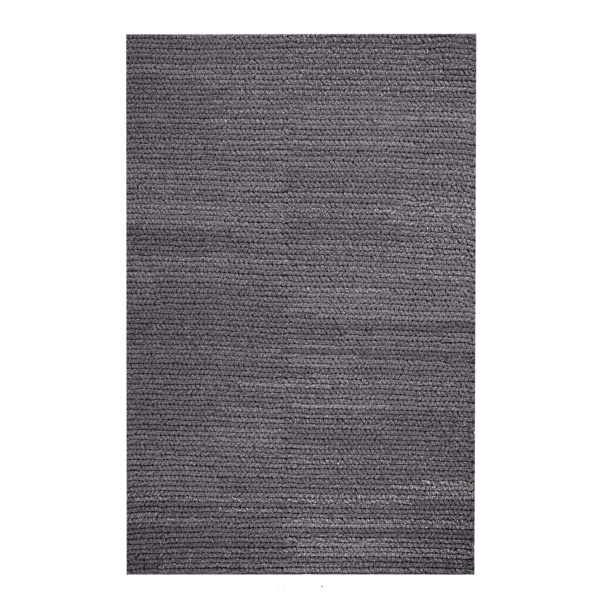 Dor handwoven chunky wool rug in charcoal, woven in thick cords, in a living room