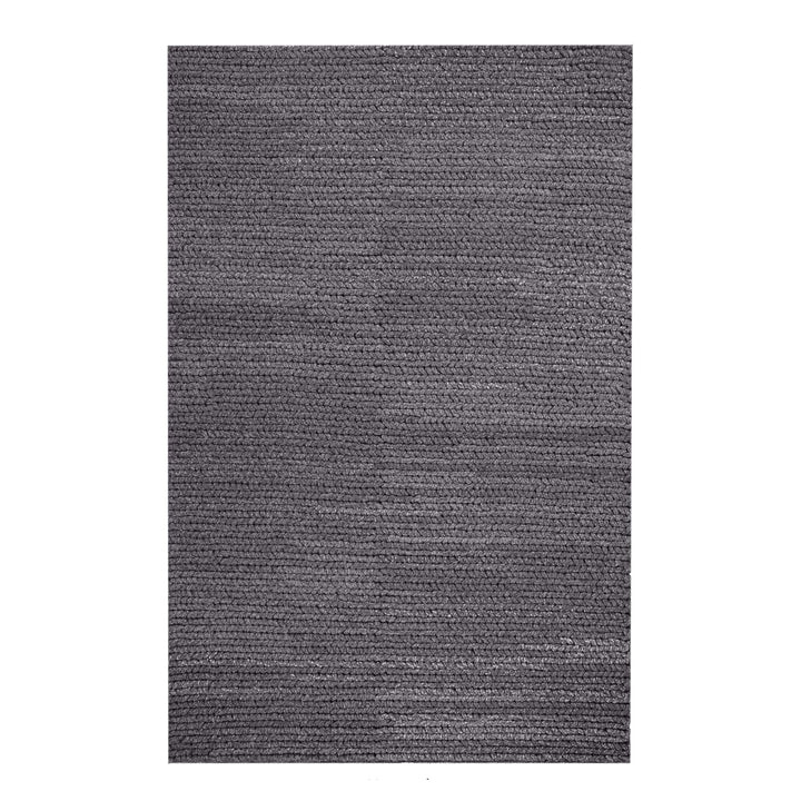 Dor handwoven chunky wool rug in charcoal, woven in thick cords, in a living room