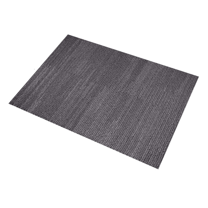 Dor handwoven chunky wool rug in charcoal, woven in thick cords, in a living room