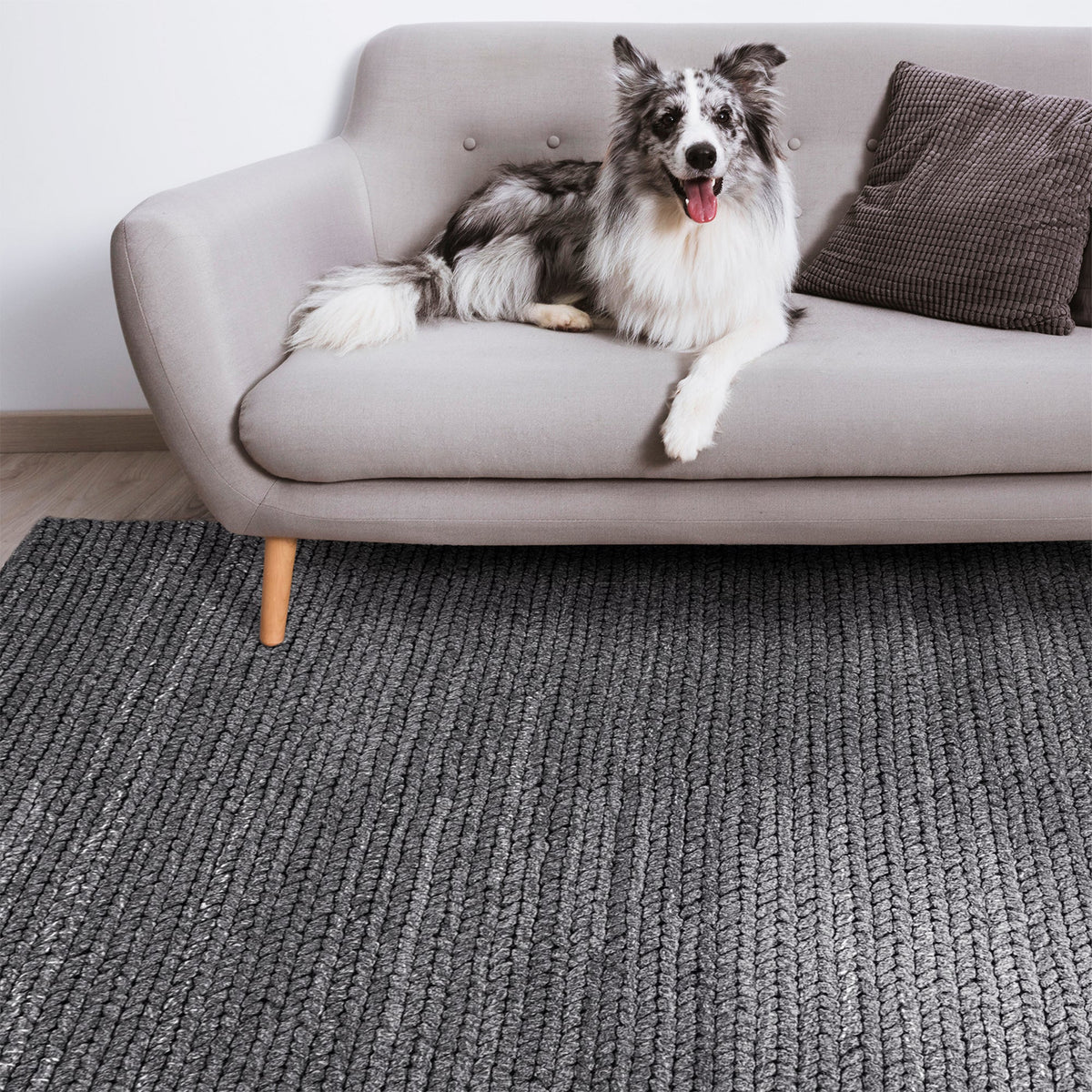 Dor handwoven chunky wool rug in charcoal, woven in thick cords, in a living room