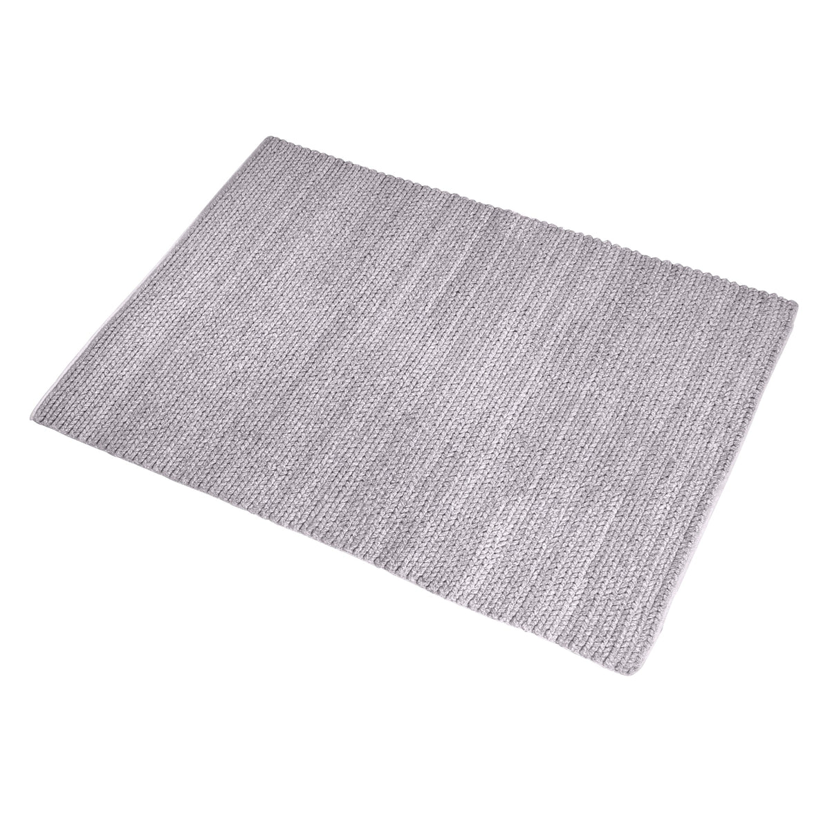 Dor handwoven chunky wool rug in charcoal, woven in thick cords, in a living room
