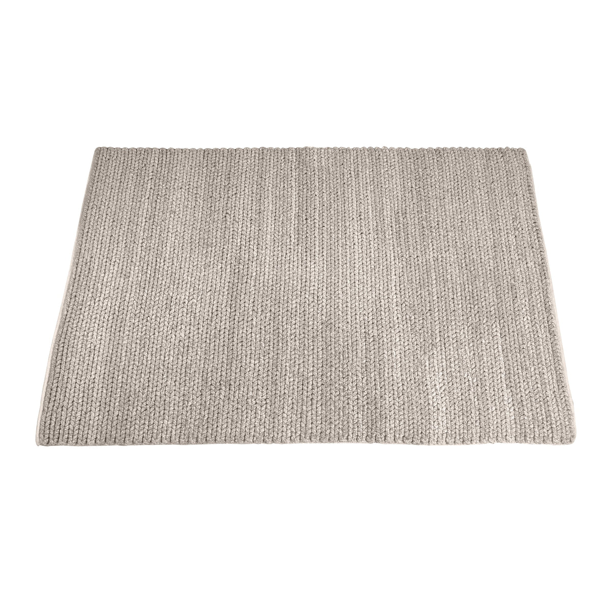 Dor handwoven chunky wool rug in charcoal, woven in thick cords, in a living room