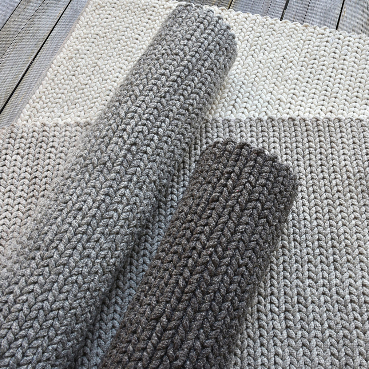 Dor handwoven chunky wool rug in charcoal, woven in thick cords, in a living room