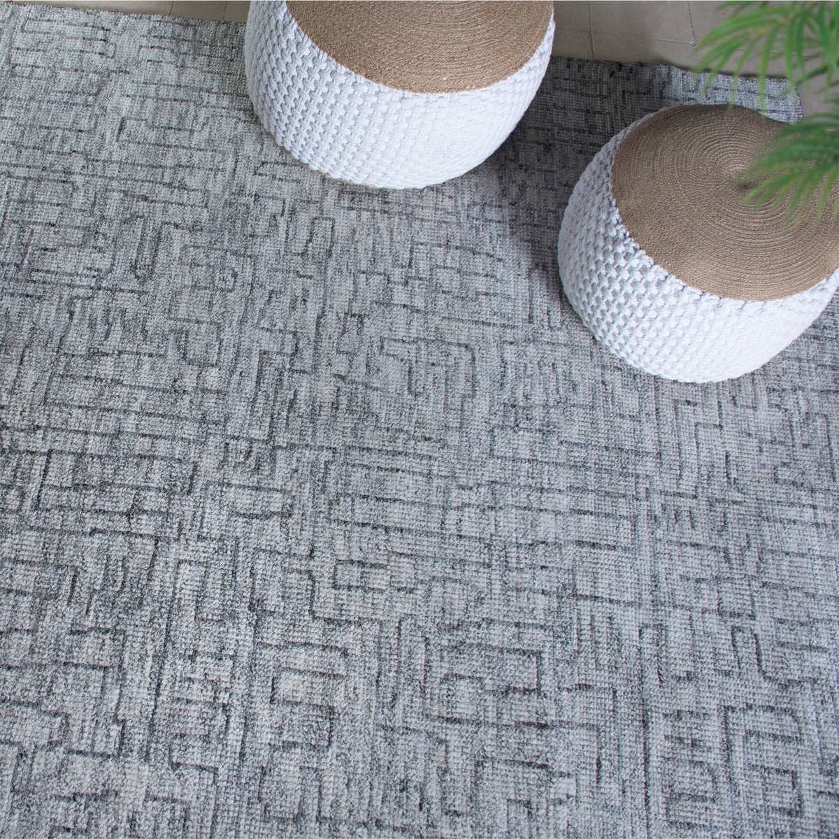 Barsaat hand-knotted wool and viscose rug with mottled blue-grey brick lines, in a living room