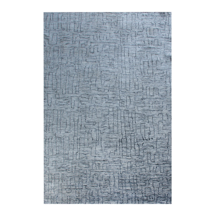 Barsaat hand-knotted wool and viscose rug with mottled blue-grey brick lines, in a living room