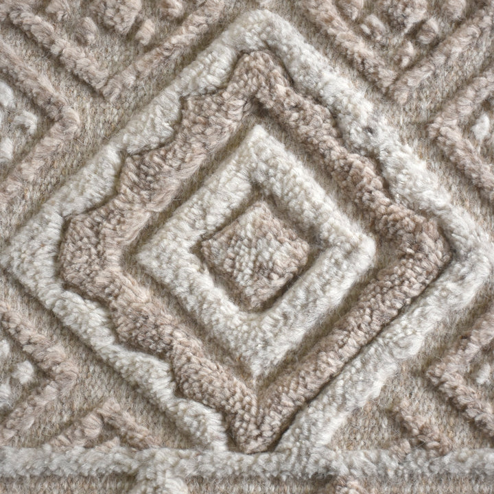 Malai hand-knotted ivory wool rug with a raised diamond lattice, under a dining table