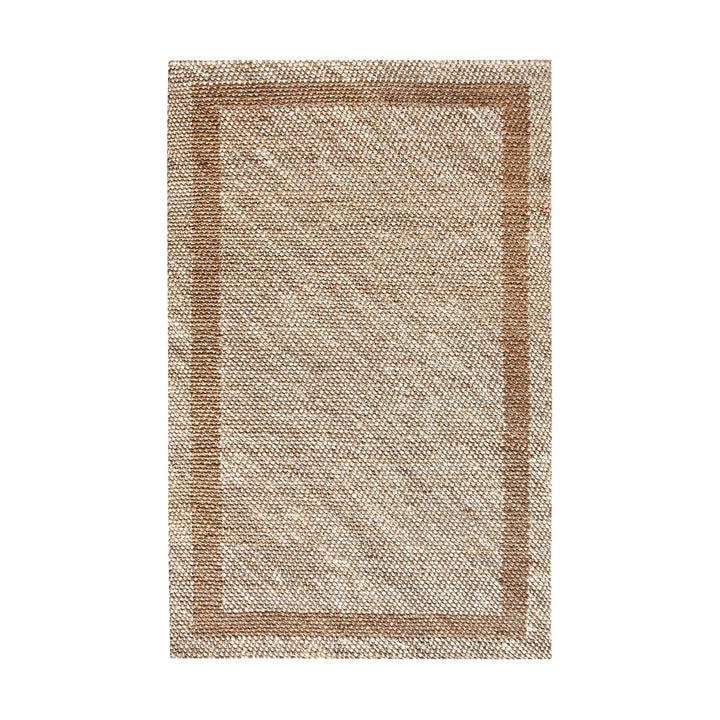 Chaukhat handwoven flatweave jute and wool rug in jute tan with a rust-brown border, in a living room