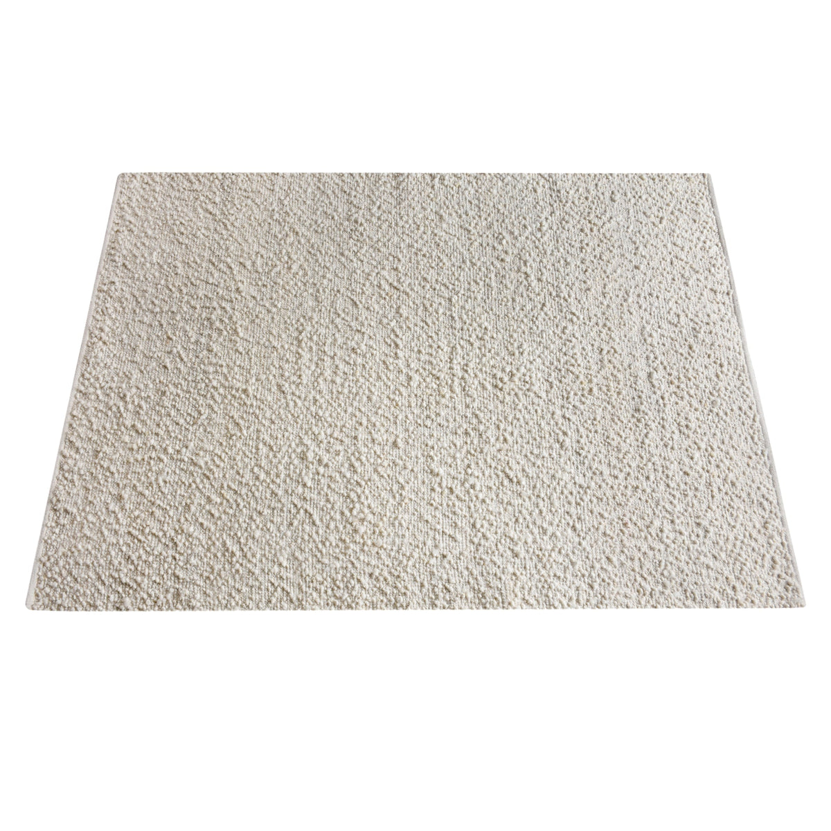 Lambswool handwoven ivory wool and jute rug with a bouclé pebble pile, in a living room