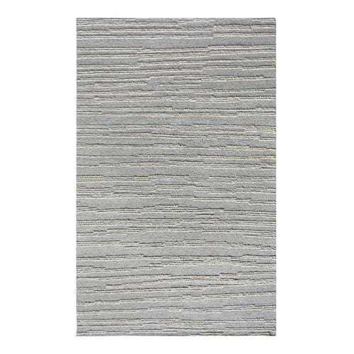 Surma hand-knotted wool rug in slate grey with raised ivory vertical stripes, in a living room
