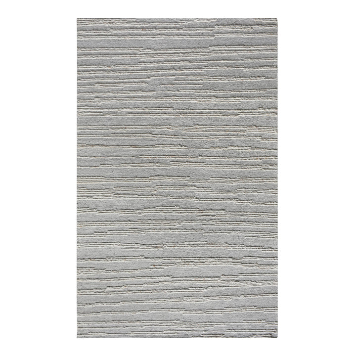 Surma hand-knotted wool rug in slate grey with raised ivory vertical stripes, in a living room