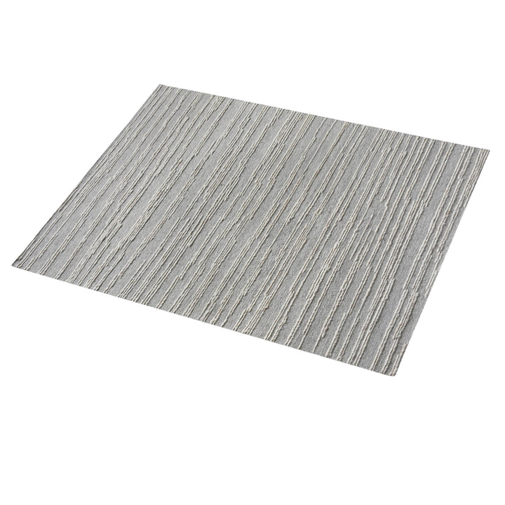 Surma hand-knotted wool rug in slate grey with raised ivory vertical stripes, in a living room