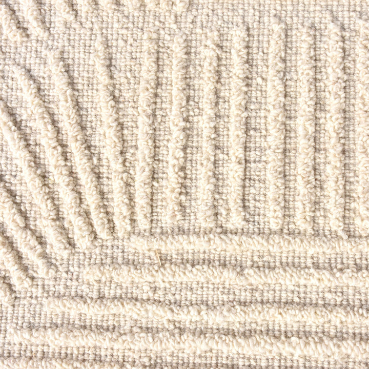 Kona handwoven cream wool rug with fine carved linear geometry, in a bedroom