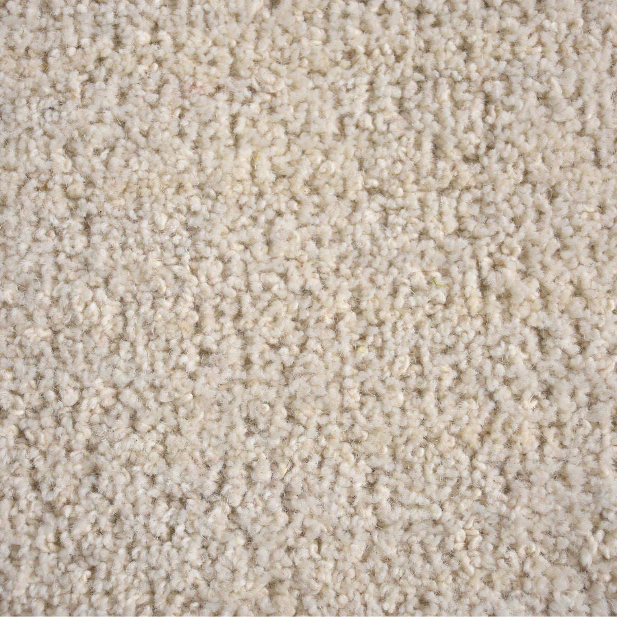 Gol handwoven wool rug in plain cream with a soft cut pile and a curved edge, in a nursery