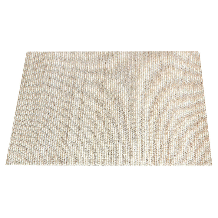 Kai handwoven hemp rug in natural with a sage cast and a tight chunky weave, in a living room