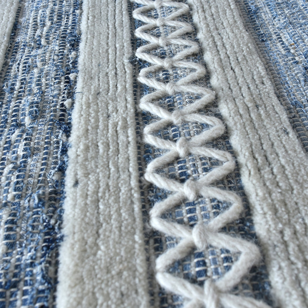 Breton handwoven denim and wool rug with blue and cream horizontal stripes, in a home office