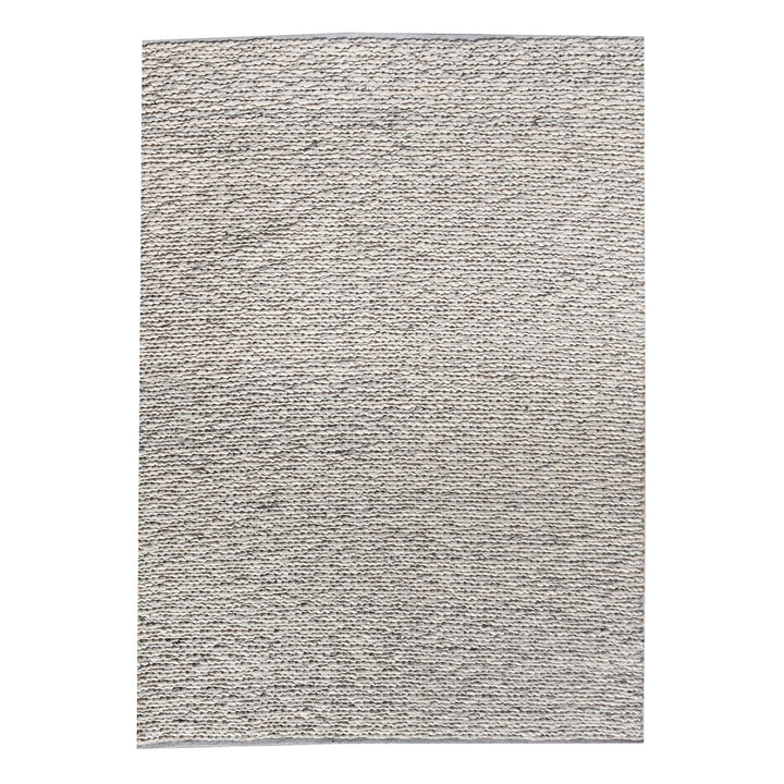 Rassi handwoven wool rug with a chunky braided weave in ivory, oatmeal and grey, in a living room