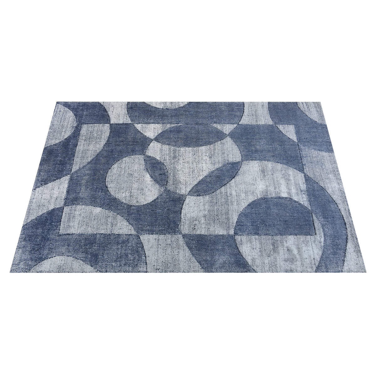 Mauj handwoven viscose and PET rug with denim blue overlapping circles on grey, in a living room
