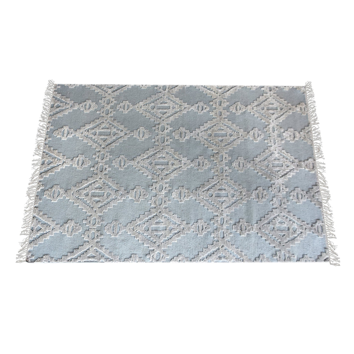 Mor hand-knotted wool rug with ivory raised diamonds on duck egg blue, in a bedroom