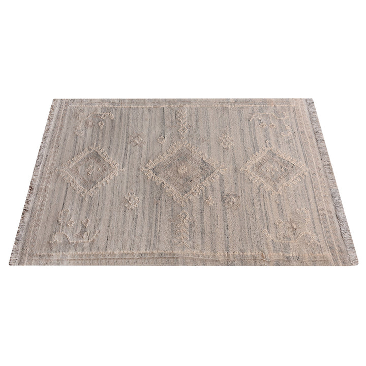 Canyon flatweave wool rug with ivory and taupe tribal diamonds, in a living room