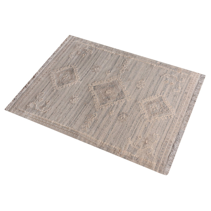 Canyon flatweave wool rug with ivory and taupe tribal diamonds, in a living room