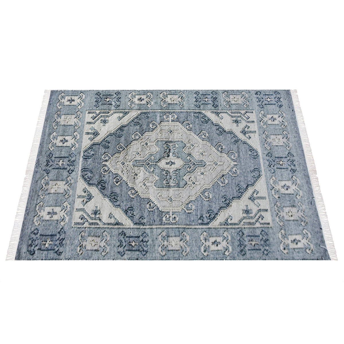 Courtyard flatweave slate blue recycled PET rug with an ivory Heriz medallion, on a patio
