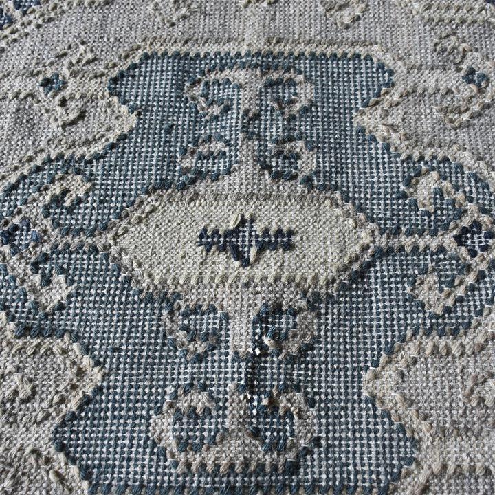 Courtyard flatweave slate blue recycled PET rug with an ivory Heriz medallion, on a patio