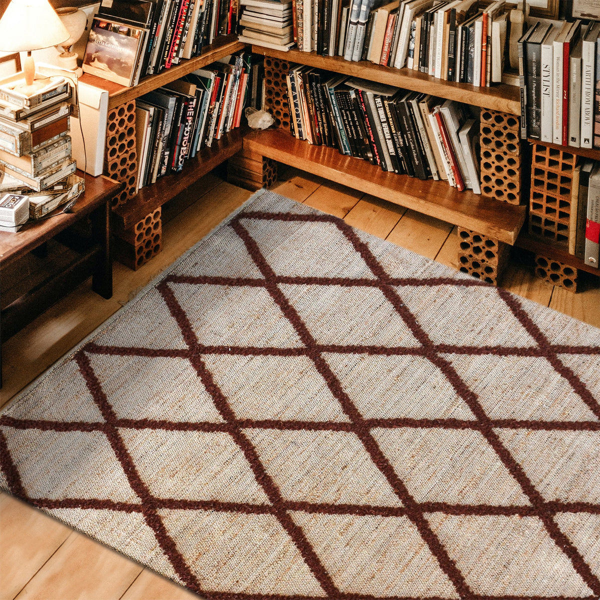 Lantern handwoven ivory hemp and PET rug with a rust diamond lattice, in a living room