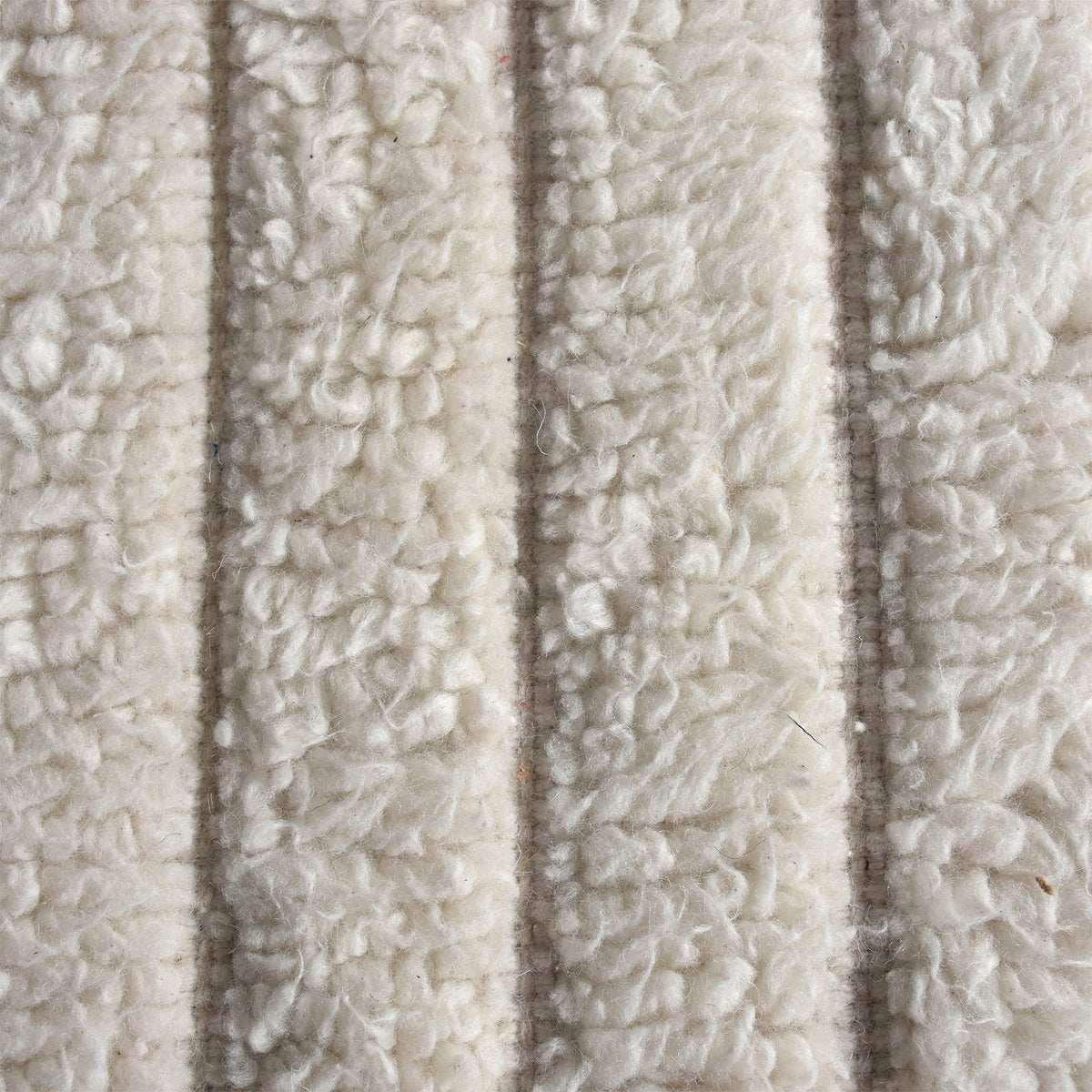 Sopan handwoven New Zealand wool rug with broad ivory ridges, in a living room