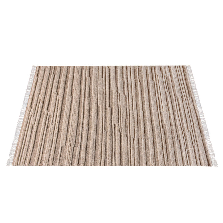 Pankti hand-knotted NZ wool rug in cream and oat with carved vertical stripes, in a dining room