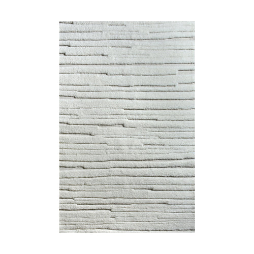 Bark handwoven ivory wool rug with carved vertical ridges, in a living room