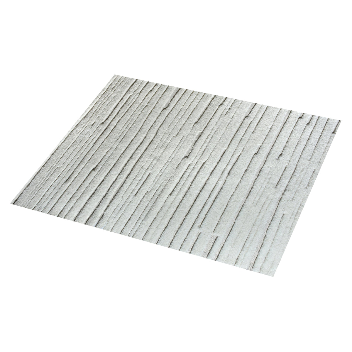 Bark handwoven ivory wool rug with carved vertical ridges, in a living room