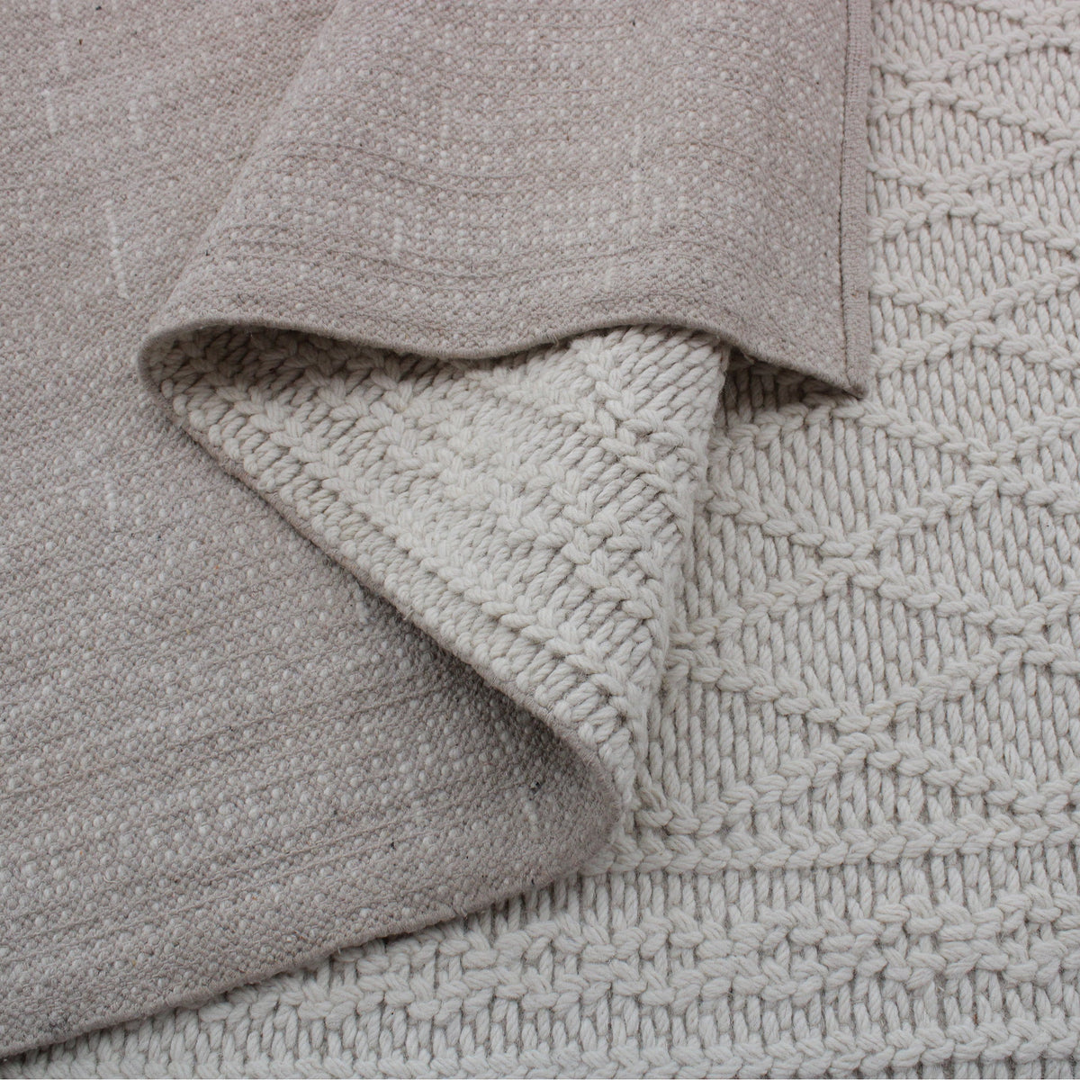 Jaal handwoven ivory wool rug with a raised cabled diamond lattice, in a living room
