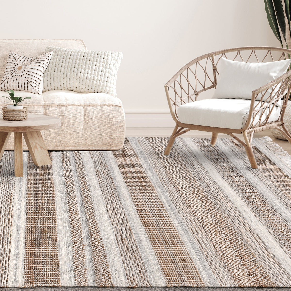 Deckchair handwoven jute and wool rug with broad ivory and tan stripes, in a living room