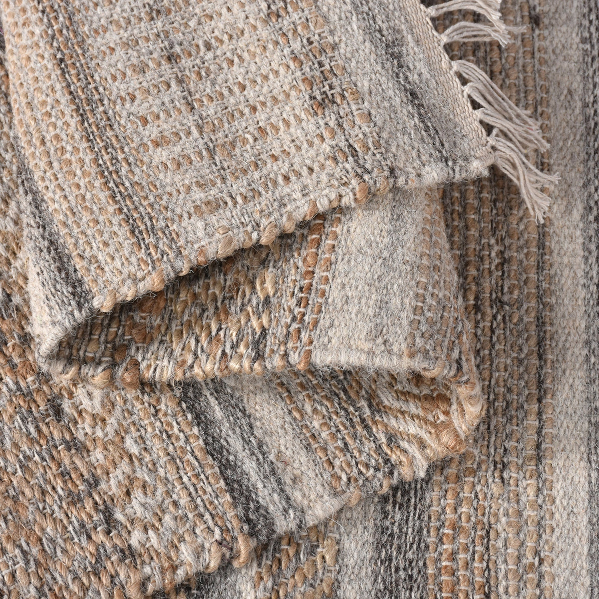 Deckchair handwoven jute and wool rug with broad ivory and tan stripes, in a living room